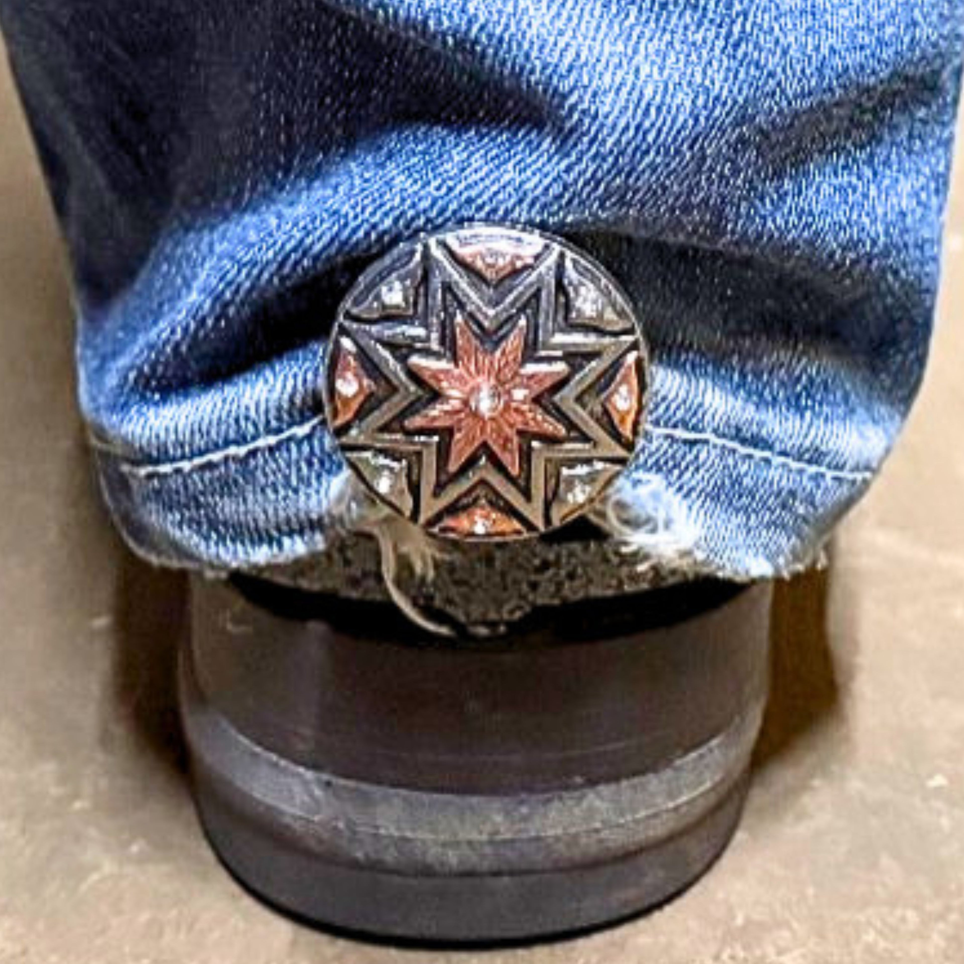 Angel Fire Cowgirl Cuff attached to the back of a cowboy boot helping keep jean hems off the ground while adding Southwestern western style and crystal accents.