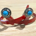 Handcrafted Blue Stone Concho Cowgirl Cuff featuring an engraved silver-tone western concho with a bright blue stone center, designed to attach to cowboy boots and help keep jean hems off the ground.
