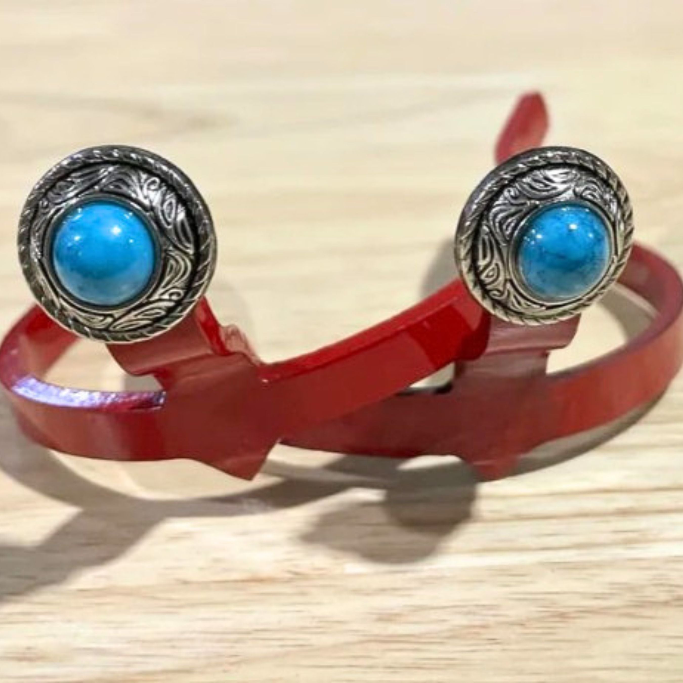Handcrafted Blue Stone Concho Cowgirl Cuff featuring an engraved silver-tone western concho with a bright blue stone center, designed to attach to cowboy boots and help keep jean hems off the ground.
