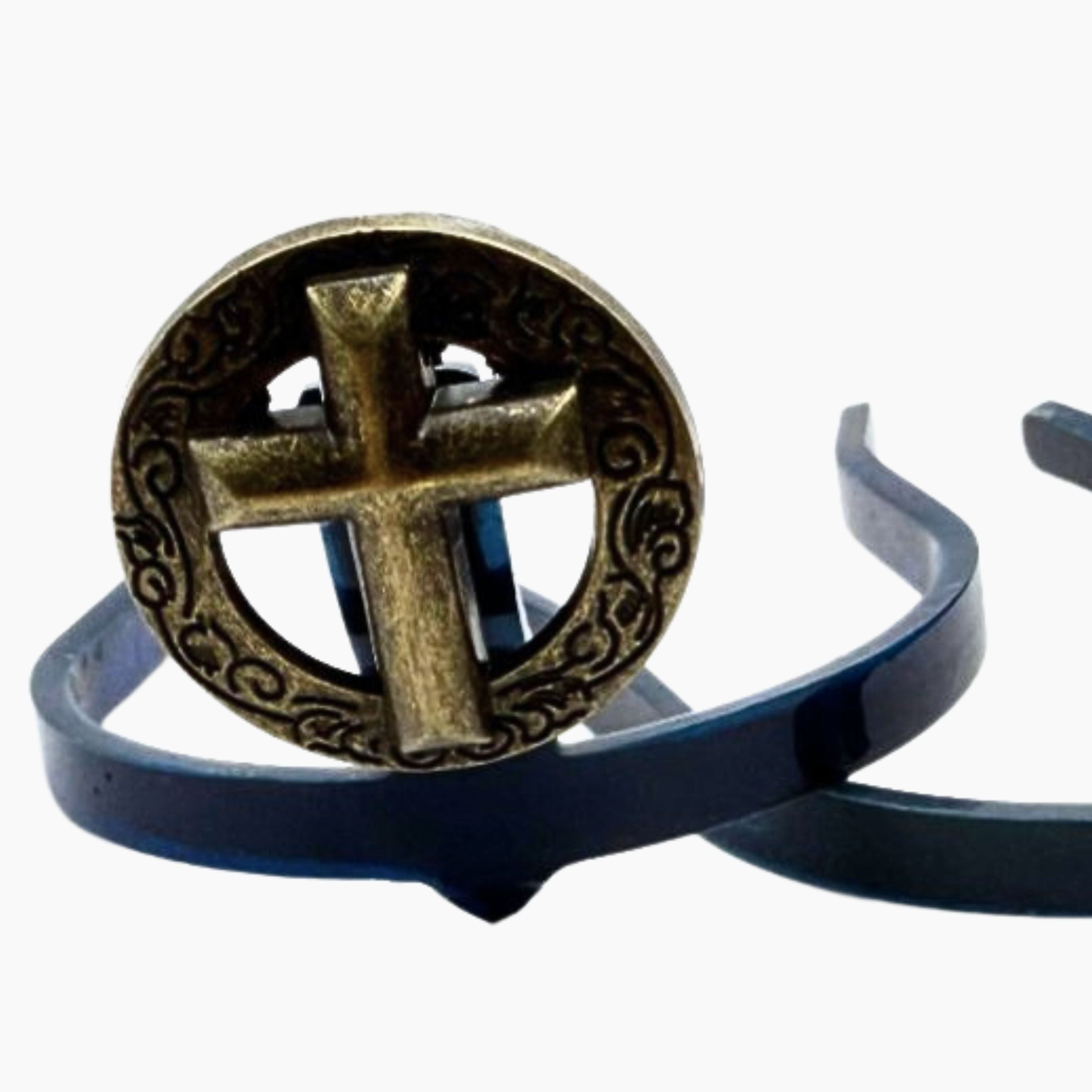 Bronze Cross Cowgirl Cuff on a blue boot accessory base featuring a raised cross within an antique bronze western frame, handcrafted to help keep jean hems off the ground.