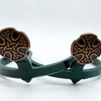 Celtic Cross Cowgirl Cuff featuring antique copper knotwork cross design on a handcrafted western boot accessory with green cuff base, designed to keep jean hems off the ground.