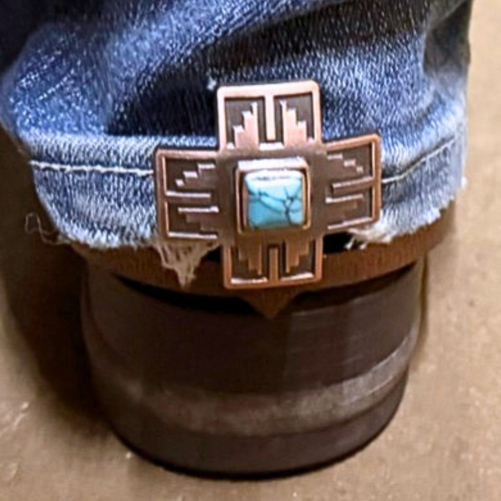 Copper Cross with Turquoise Stone Cowgirl Cuff attached to the back of a cowboy boot, demonstrating how the handcrafted western boot accessory helps keep jean hems off the ground while adding Southwestern style.