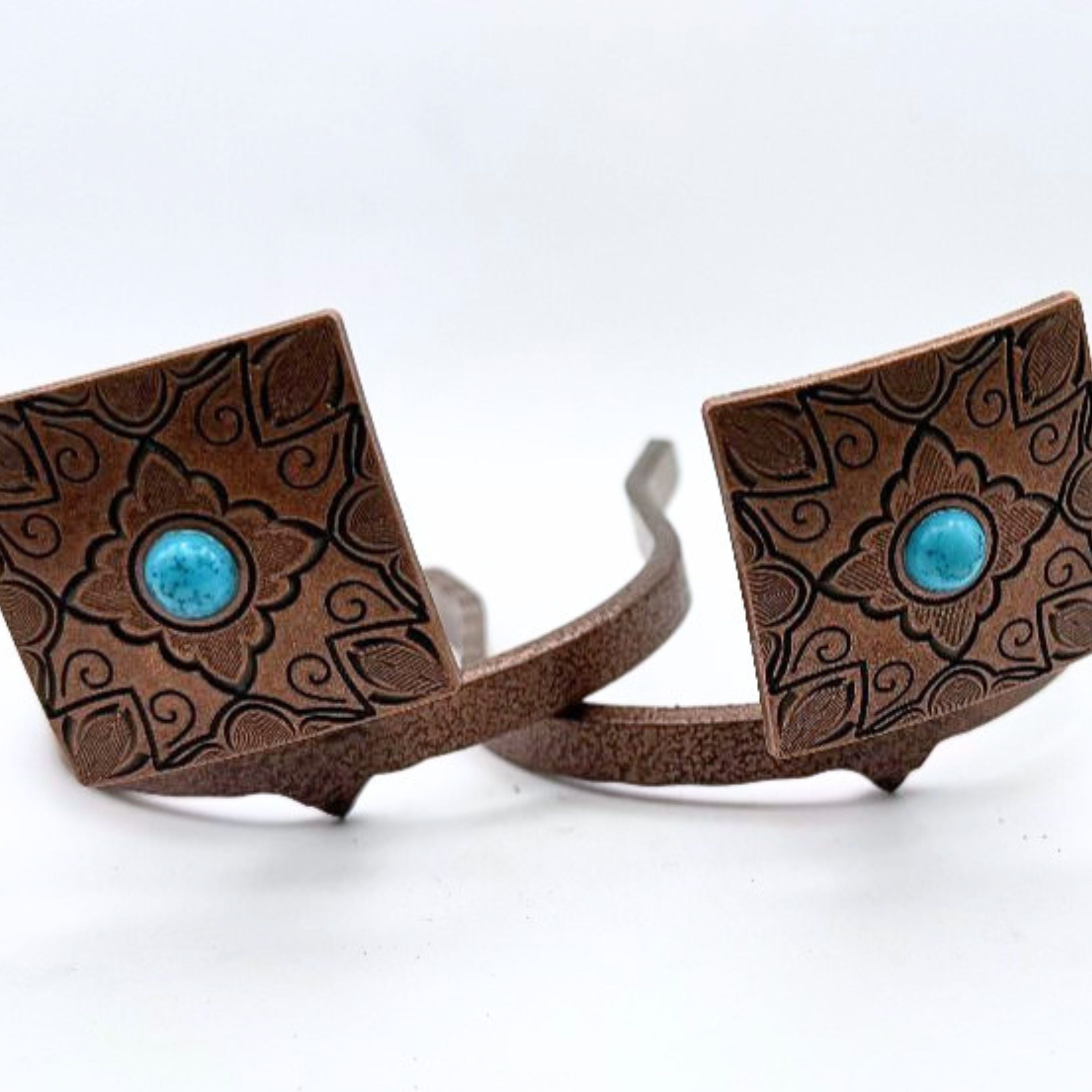 Copper floral square Cowgirl Cuff featuring engraved western scrollwork and a turquoise center stone. Handcrafted cowboy boot accessory designed to keep jean hems off the ground while adding western style.