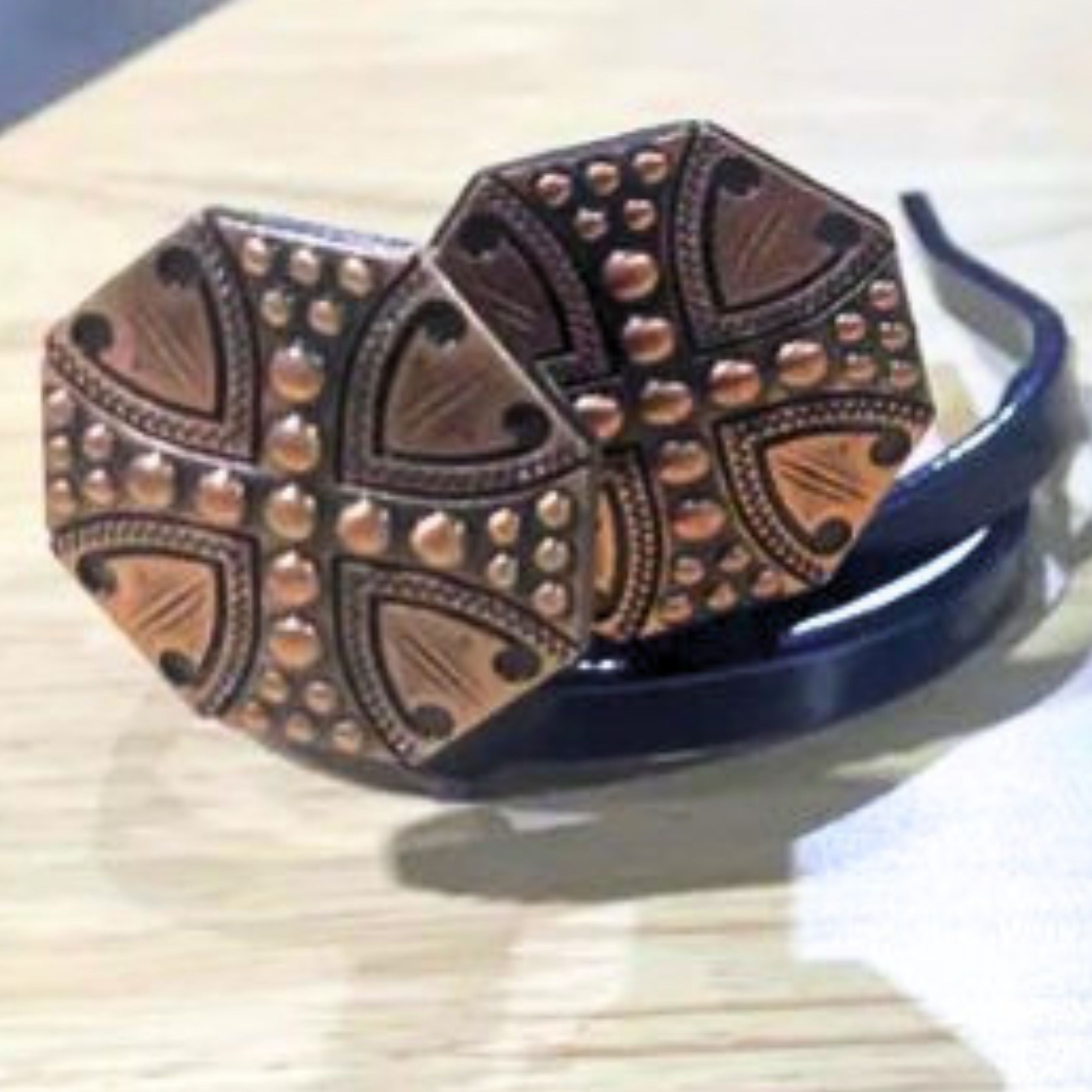 Copper studded concho Cowgirl Cuff featuring engraved western detailing, geometric copper accents, and raised beadwork. Handcrafted cowboy boot accessory designed to keep jean hems off the ground.