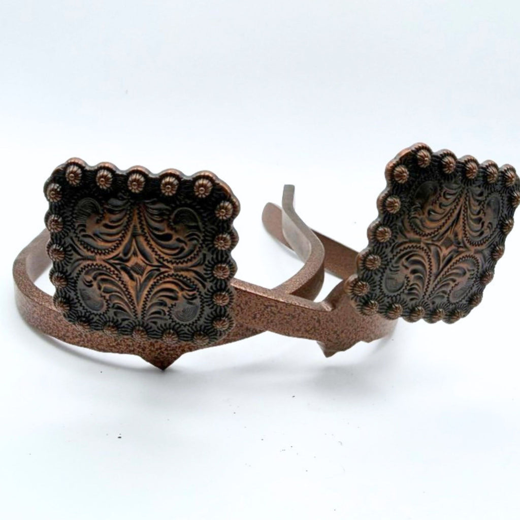 Copper square Cowgirl Cuff featuring engraved western tooling, floral scrollwork, and decorative beaded edges. Handcrafted cowboy boot accessory designed to keep jean hems off the ground.