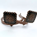 Copper square Cowgirl Cuff featuring engraved western tooling, floral scrollwork, and decorative beaded edges. Handcrafted cowboy boot accessory designed to keep jean hems off the ground.