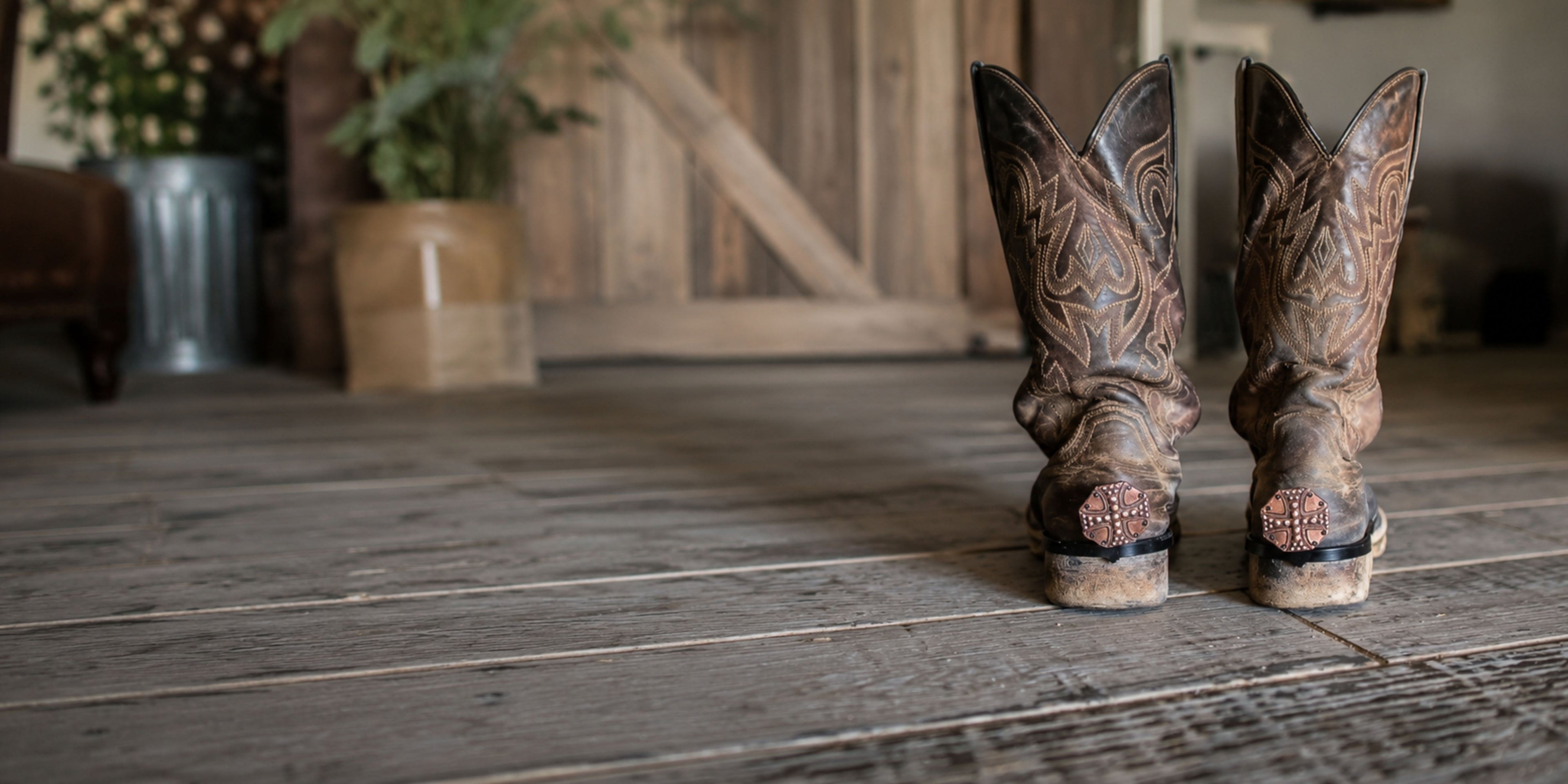 Handcrafted Cowgirl Cuff western boot cuffs attached to cowboy boots and jeans, protecting pant hems while adding western style and fashion.