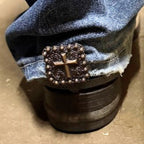 Faith-inspired Cross Berry Square Cowgirl Cuff attached to the back of a cowboy boot helping keep jean hems off the ground while adding western style.