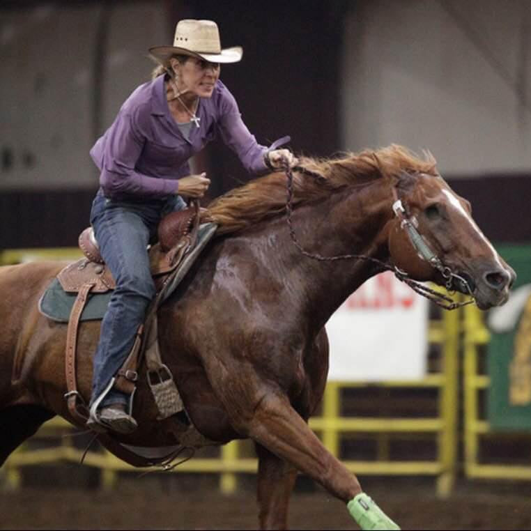 Darcy, founder of Cowgirl Cuff, rides her horse during a western riding event. Her passion for the western lifestyle inspired the creation of Cowgirl Cuff, handcrafted boot accessories designed to protect jeans while adding western style.