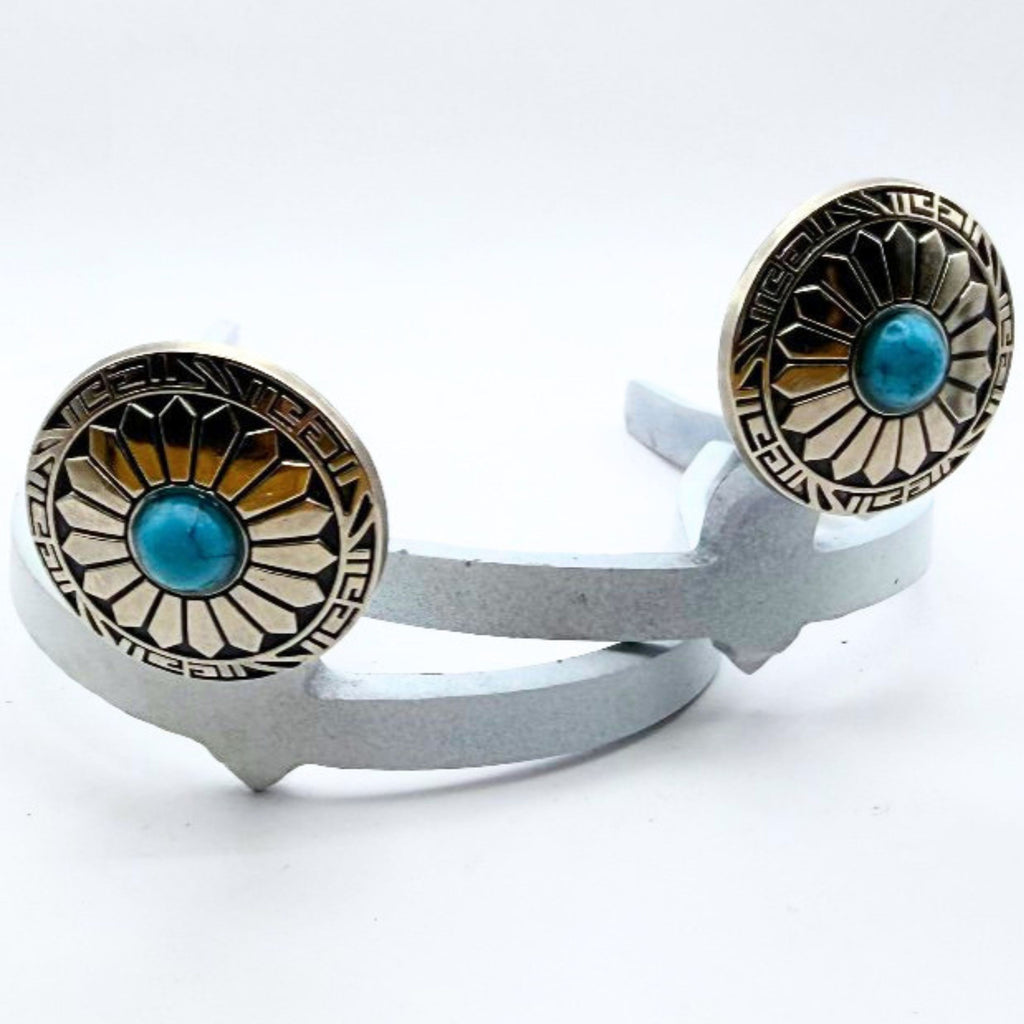 Close-up of the Decorative Sunflower Cowgirl Cuff featuring a turquoise-style center stone, radiating sunflower pattern, and western metalwork details.