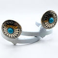 Close-up of the Decorative Sunflower Cowgirl Cuff featuring a turquoise-style center stone, radiating sunflower pattern, and western metalwork details.