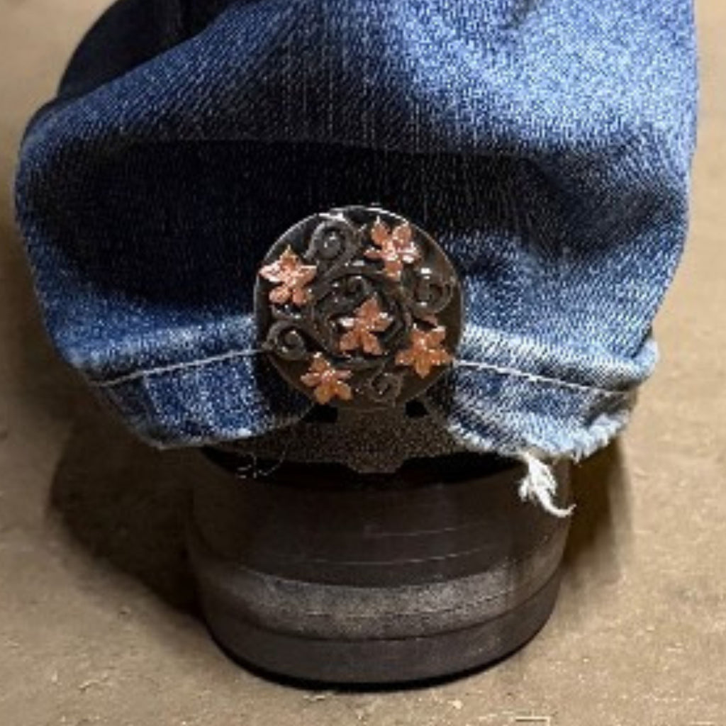 Floral Cowgirl Cuff attached to the back of a cowboy boot featuring copper-tone flowers and western scrollwork while helping keep jeans off the ground.