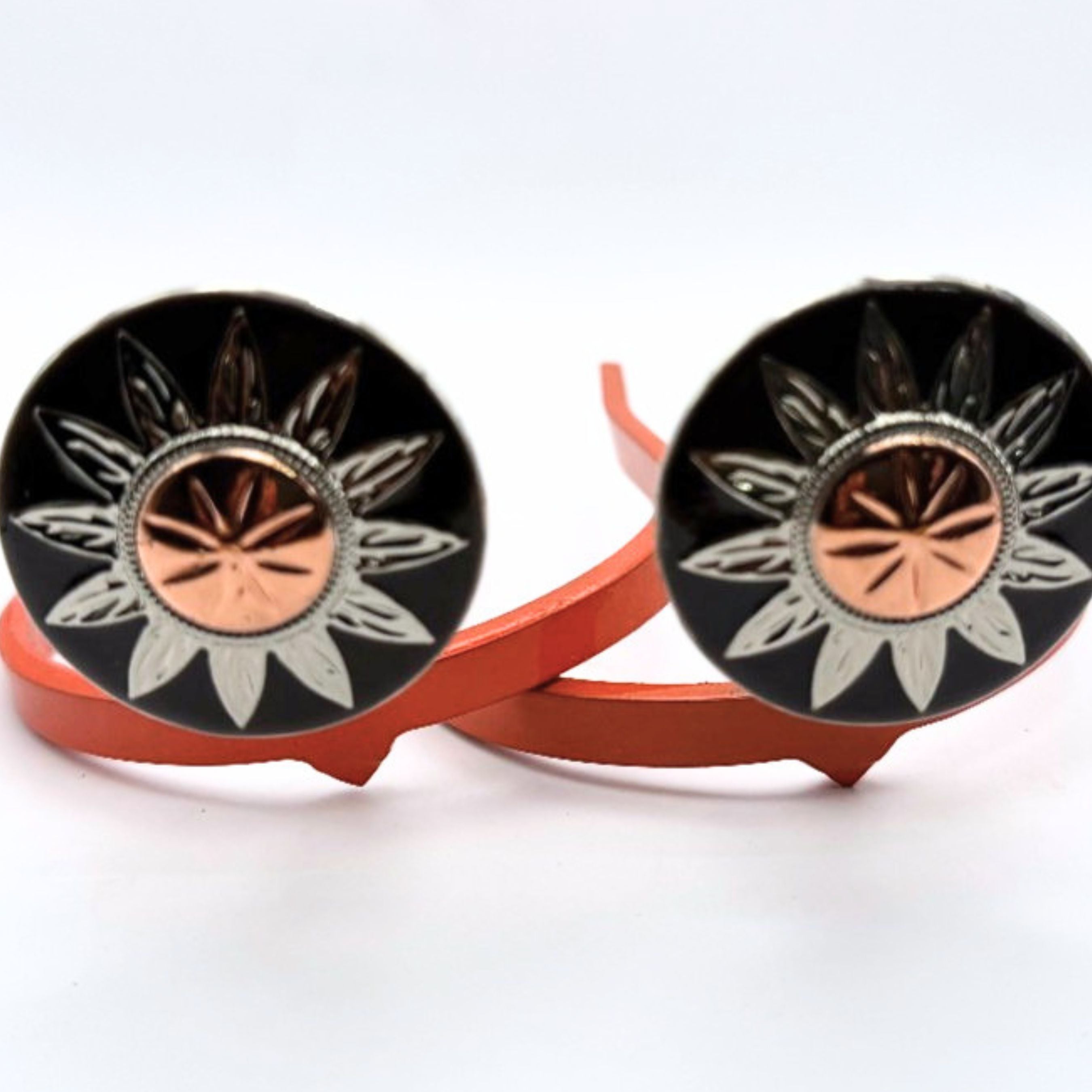 Here Comes the Sun Cowgirl Cuff featuring a silver sunburst design with a copper center on a handcrafted western boot accessory designed to keep jean hems off the ground while adding feminine western style.