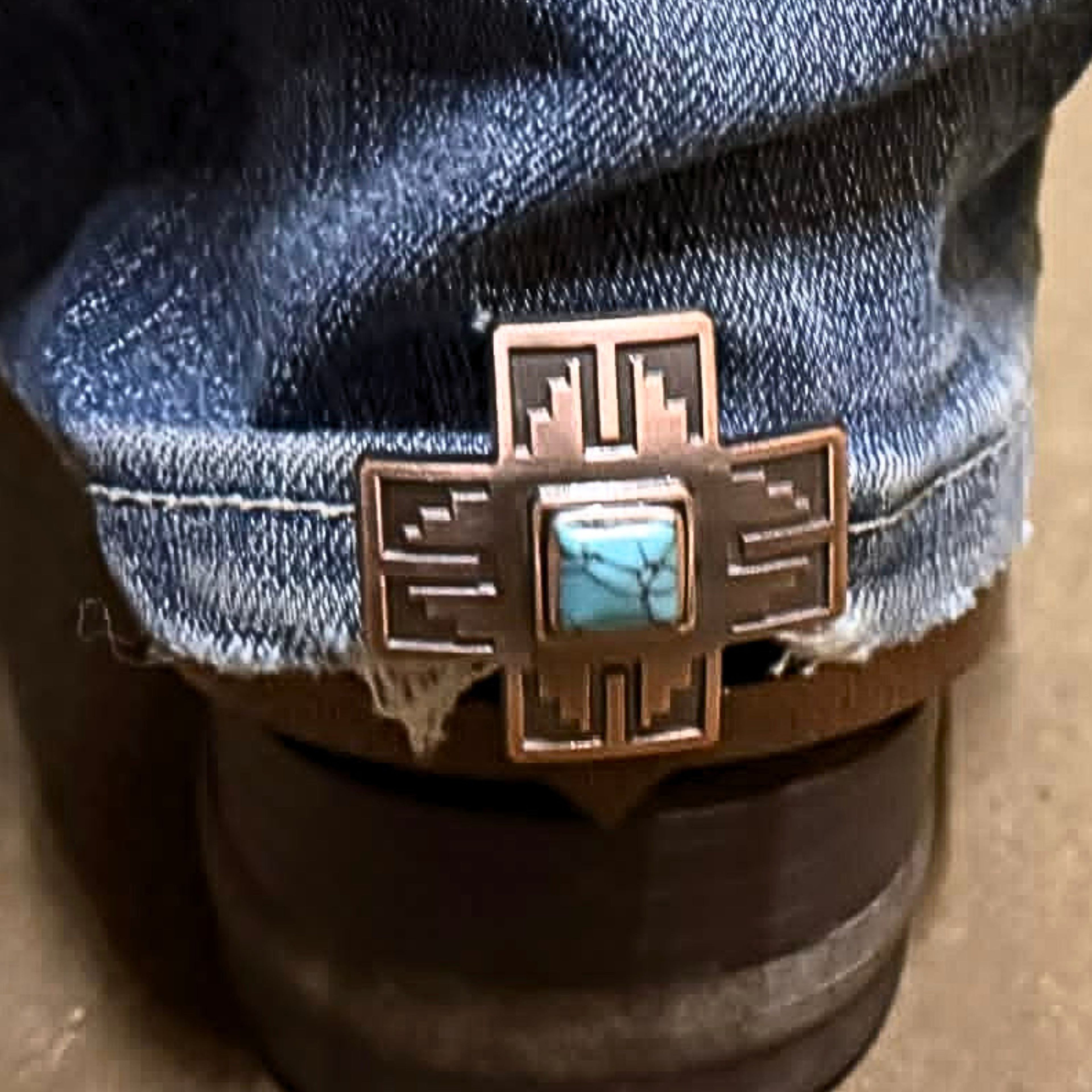 Silver cross Cowgirl Cuff with turquoise stone attached to the back of a cowboy boot. Handcrafted western boot accessory designed to keep jean hems off the ground while adding western style.