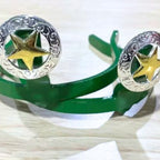 Western Star Cowgirl Cuff featuring a gold-tone five-point star, engraved silver scrollwork, and handcrafted western styling on a green cuff base.