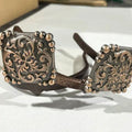 Handcrafted Yuma Square Cowgirl Cuff featuring western scrollwork engraving, beaded border accents, and mixed-metal copper and silver tones designed to attach to cowboy boots and help keep jean hems off the ground.